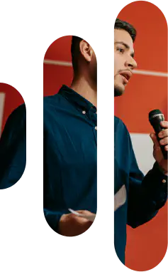 Person speaking into a microphone on stage.