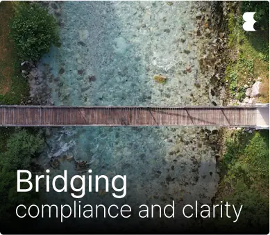 Aerial view of bridge over clear water stream.
