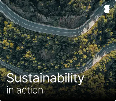 Winding road through lush forest promoting sustainability.