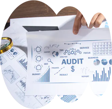 Financial audit documents and graphs on desk.